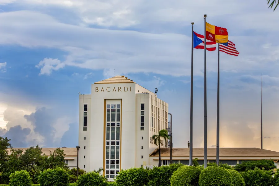BACARDÍ building in Cataño, Puerto Rico, with flags against a blue sky