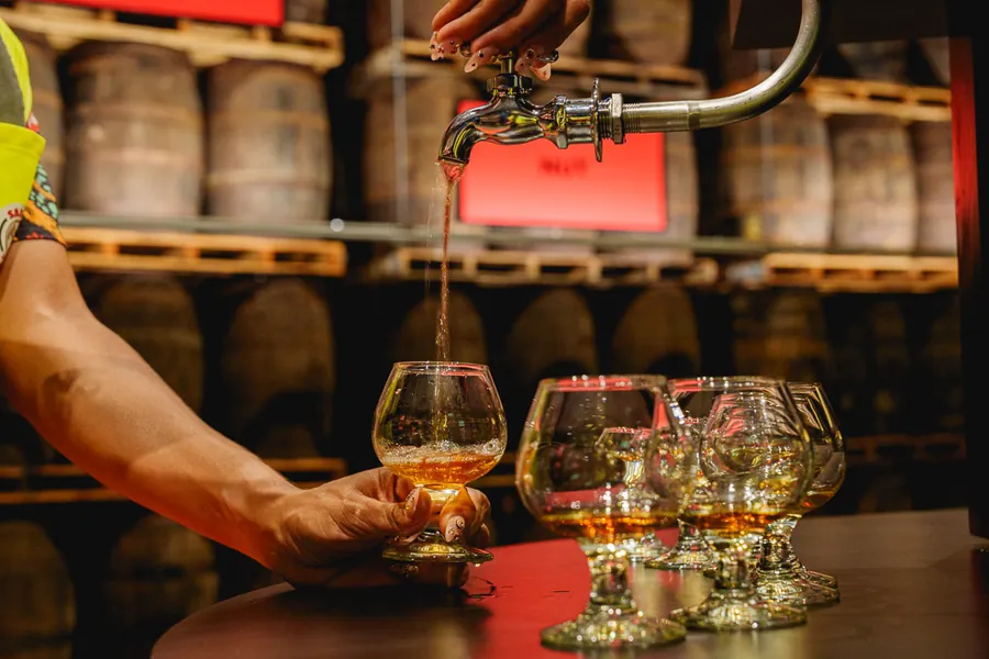 BACARDÍ rum pours straight from the barrel into tasting glasses at Casa BACARDÍ